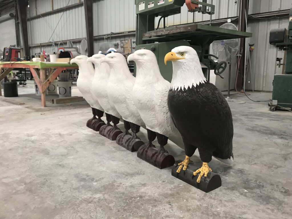 Bird Deterrent Technology - A row of eagle effigies on a floor ready for painting.
